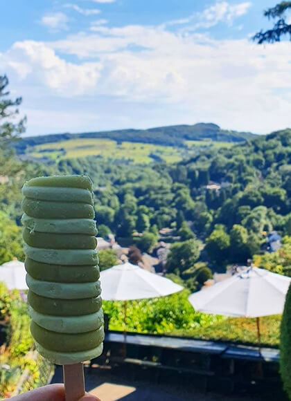 Close up of an ice cream in front of scenic views over Matlock